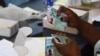 FILE - An official of the Independent National Electoral Commission sorts permanent voters cards at a ward in Lagos, Nigeria, Jan. 12, 2023. The INEC office in Anambra state was attacked Feb. 1, 2023, but its permanent voter cards were spared, members of the commission said. 