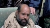 A mobile phone picture taken by one of his guards shows Saif al-Islam Gaddafi sitting with his captors in Obari airport November 19, 2011