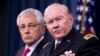 Joint Chiefs Chairman Gen. Martin Dempsey (r) accompanied by Defense Secretary Chuck Hagel, speaks during a news conference at the Pentagon, Dec. 4, 2013. 
