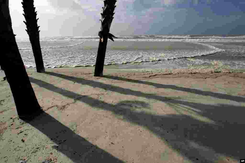 The sun breaks through the bands of storms as the first real impacts of Isaac reach the beaches of Gulf Shores, Ala. at high tide, where all access to the beach is closed Aug. 28, 2012.