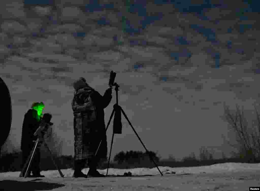 Amateur astronomers watch a green comet named Comet C/2022 E3 (ZTF) outside Omsk, Russia, Feb. 1, 2023.