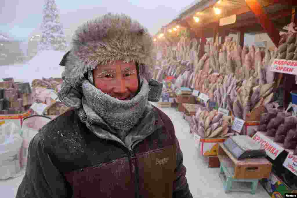 Vendor Yegor Dyachkovsky, 45, poses for a picture at an open-air market on a frosty day in Yakutsk, Russia. Yakutsk, one of the Russia's north-most cities, is hit by an extreme cold snap as the air temperature plunged as low as - 51° C (- 59.8° F). 