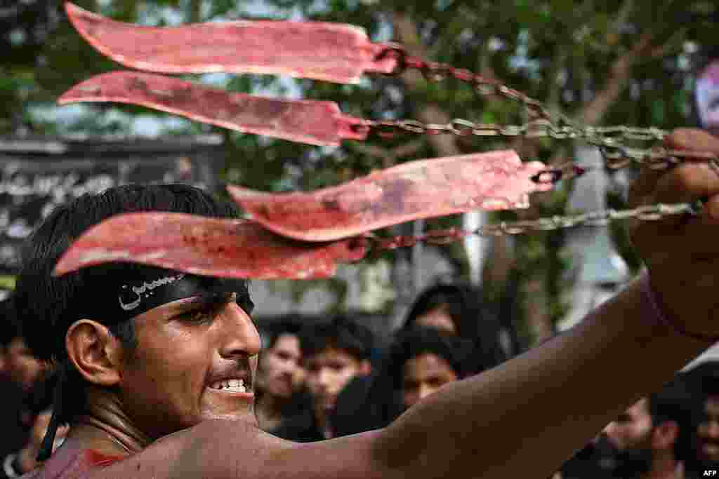 A Shi'ite Muslim mourner self-flagellates during a Muharram procession on the ninth day of Ashura in Islamabad, Pakistan.