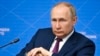 Russian President Vladimir Putin listens during a youth forum in Moscow, July 20, 2022. 