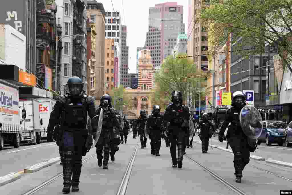 Riot Police respond as protesters rally against the construction industry's COVID-19 mandates, in Melbourne, Australia.