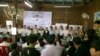 Founders and representatives of the Grassroot Democratic Party (GDP) stand up to show their faces after an election held on August 2, 2015 at a residence in Phnom Penh’s Sen Sok district. (Hul Reaksmey/VOA​ Khmer)