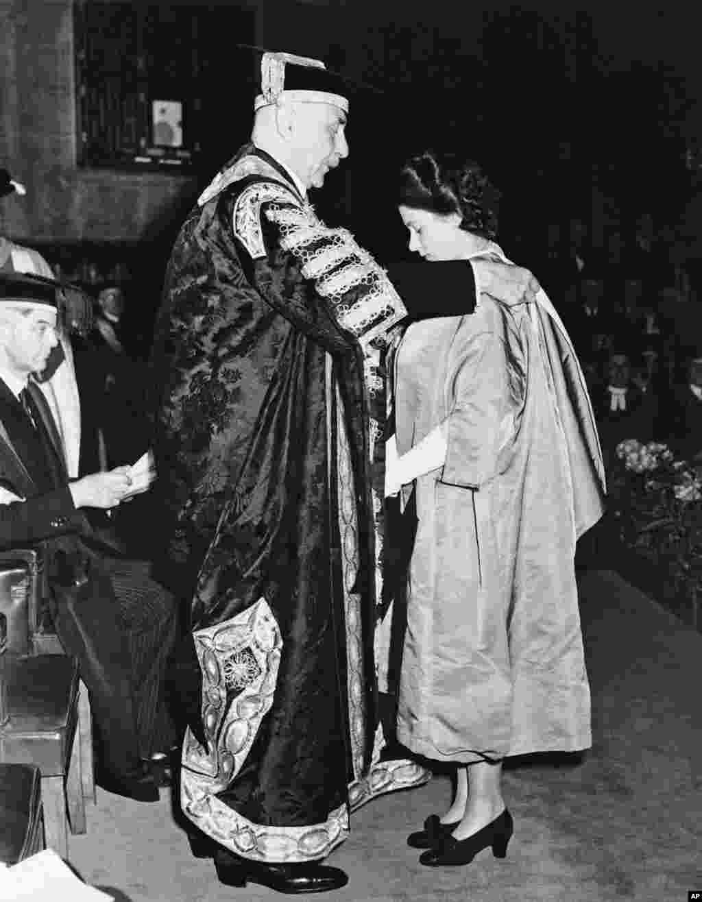 Princess Elizabeth receives the hood of a Bachelor of Music from the Earl of Athlone, Chancellor of London University, at the University's Senate House in London, July 10, 1946.