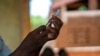 FILE - Health officials prepare to administer a vaccine in the Malawi village of Tomali, Dec. 11, 2019. This week, Nigeria announced provisional approval of the R21 vaccine designed to prevent malaria.