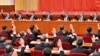 2021年11月11日，中共第19届中央委员会第六次全体会议上，政治局常委们举手表决。从左向右依次是韩正、王沪宁、栗战书、习近平、李克强、汪洋和赵乐际。照片由新华社发表，美联社提供。