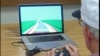 In this undated image provided by The Gazzaley Lab of the University of California, San Francisco, a study participant plays NeuroRacer in San Francisco. 