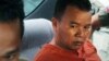 Yem Chroeum, left, an unlicensed medical practitioner, sits in a car as escorting by prison guards after a verdict announcing of the Battambang provincial court in Battambang province, northwest of Phnom Penh, Cambodia, Thursday, Dec. 3, 2015. The Cambodian court sentenced Yem Chroeum to 25 years in prison Thursday after finding him responsible for infecting more than 100 villagers with HIV, the virus that causes AIDS, by reusing unsanitized syringes. At least 10 of the infected people have died. (AP Photo/Mai Vireak)