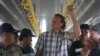 Sergei Polonsky was escorted by immigration police before he was deported from Cambodia, in a photo supplied by national police website. 
