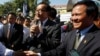 Opposition leader of Cambodia National Rescue Party Sam Rainsy, center, delivers a speech next to his Deputy President Kem Sokha, right, during a gathering to mark Human Rights Day, in front of National Assembly, in Phnom Penh, Cambodia, Wednesday, Dec. 10, 2014. (AP Photo/Heng Sinith) 