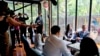 U.S. Secretary of State Antony Blinken, right, meets with U.S. Exchange Alumni at a cafe in Bangkok, July 10, 2022. 