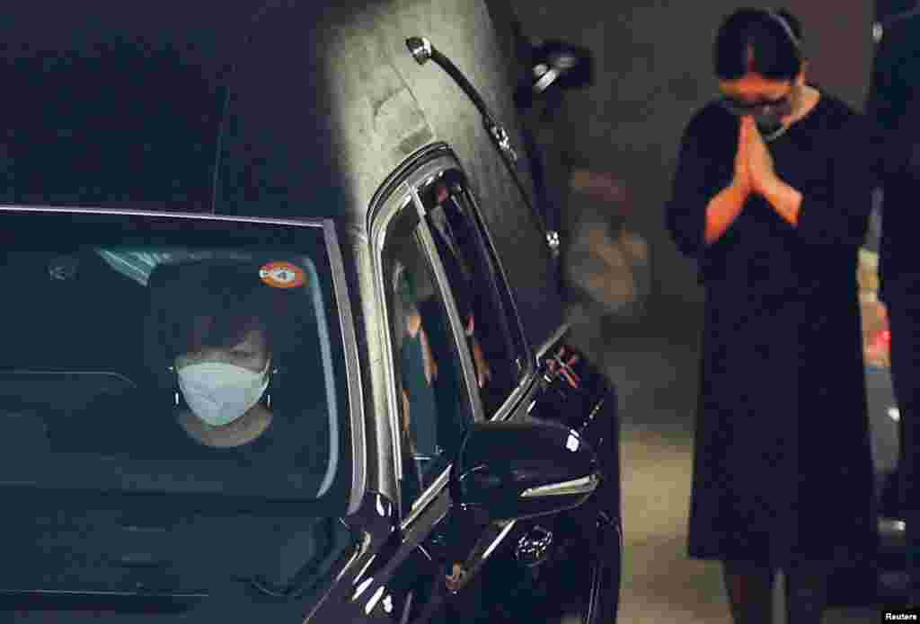 Akie Abe, wife of late former Japanese Prime Minister Shinzo Abe, who was shot while campaigning for a parliamentary election, sits in a vehicle carrying Abe&#39;s body to a night vigil at a temple in Tokyo.
