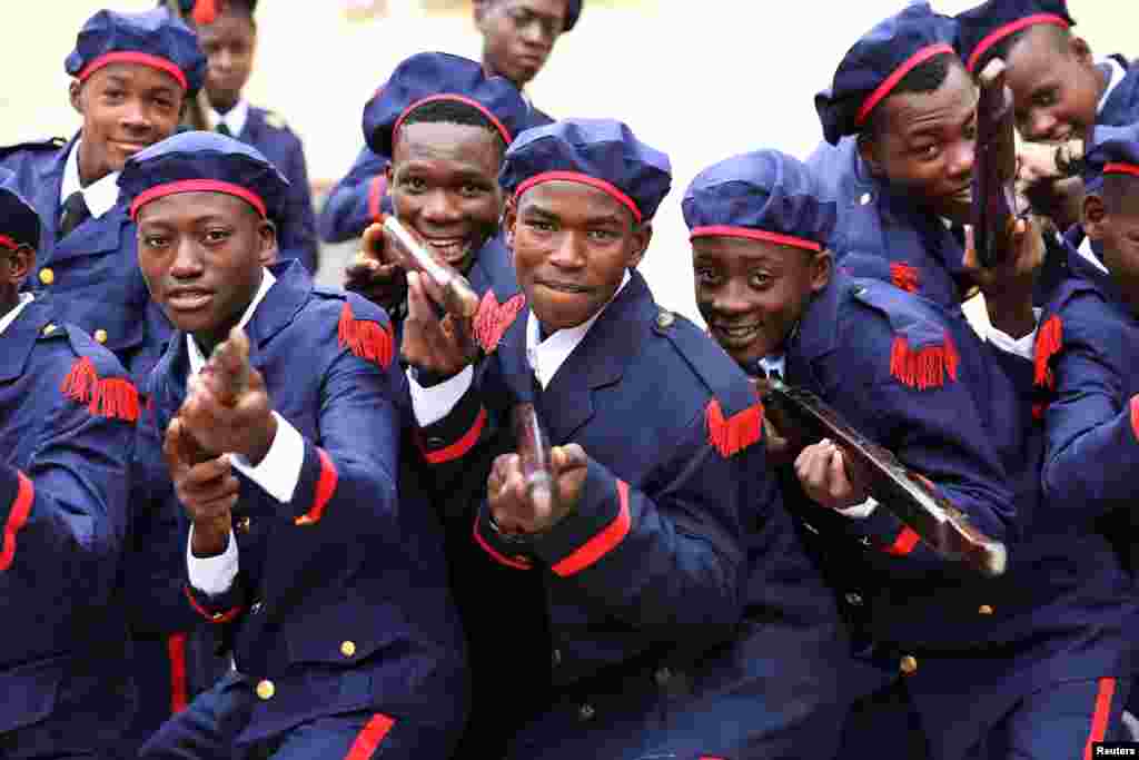 Young people pose for a photograph during celebrations for Haiti's national flag day in Arcahaie, Haiti.