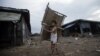 A boy carries rattan chairs at a market in Yangon, November 18, 2012.