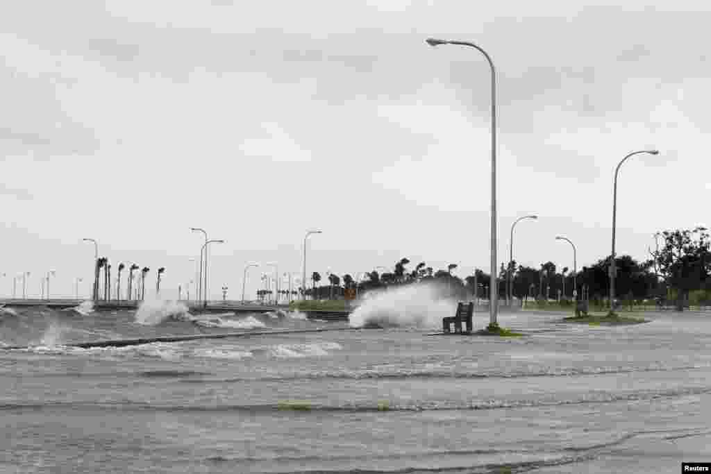 Water floods an area outside the levee system along the shore of Lake Pontchartrain as tropical storm Isaac approaches New Orleans, Louisiana, August 28, 2012.