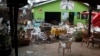 FILE - Damaged chairs and tables lie among the debris strewn after a bomb attack outside an Ethiopian restaurant in Kampala, Uganda, July 12, 2010.