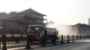 Sebuah truk menyemprotkan disinfektan di jalan di Xi'an di Provinsi Shaanxi utara China, 31 Desember 2021, di tengah lockdown karena COVID-19. (Foto: AFP)
