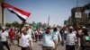 Supporters of deposed Egyptian President Mohamed Morsi march from Raba El-Adwyia square to the Republican Guards headquarters where they believe he is being held by the army in Cairo, July 7, 2013. 