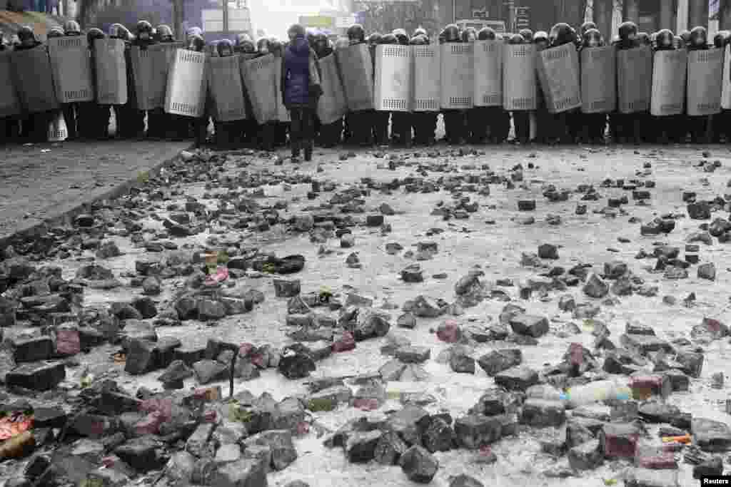 Riot police block a street, as stones used by pro-European integration protesters in recent demonstrations lie on the ground in Kyiv, Jan. 21, 2014.