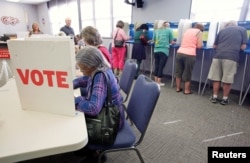 FILE - Voters fill in their ballots at a crowded polling station on North Carolina's first day of early voting for the general elections, in Carrboro, North Carolina, Oct. 20, 2016.