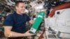 Astronaut Jack Fischer on the International Space Station with the experiment from the Beijing Institute of Technology. 