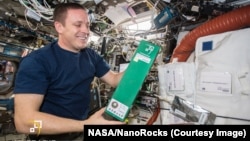 Astronaut Jack Fischer on the International Space Station with the experiment from the Beijing Institute of Technology. 
