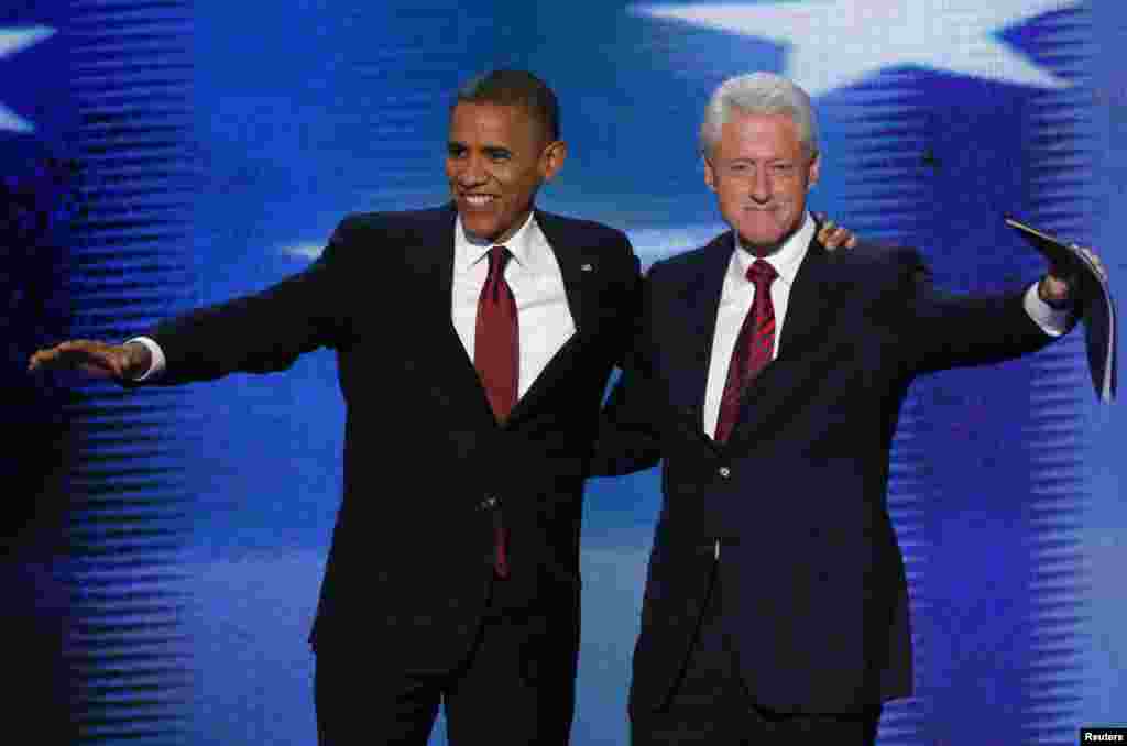 U.S. President Barack Obama (L) joins former President Bill Clinton onstage after Clinton nominated Obama for re-election during the second session of the Democratic National Convention in Charlotte, North Carolina, September 5, 2012.