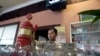 A bar tender pours beer for customers in Phnom Penh, Cambodia, file photo.