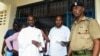 Detectives escort Ezekiel Ombok Odero at the police headquarters in Mombasa