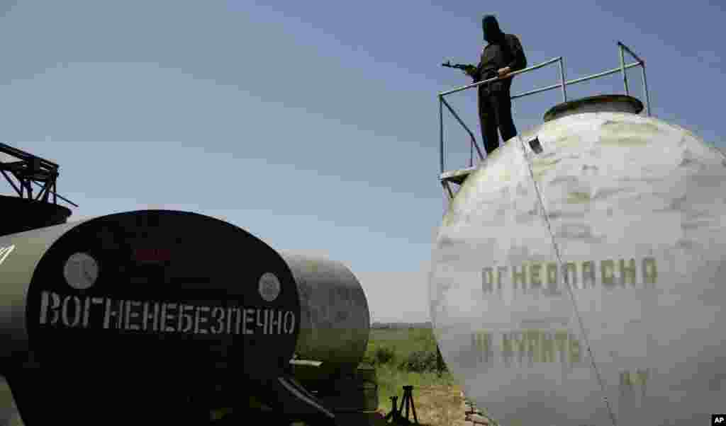 Seorang pria bersenjata dari Batalion Donbass, sebuah kelompok milisia sukarela yang mendukung persatuan Ukraina, di sebuah markas di desa Velyka Novosilka, Ukraina timur (16/5). (AP/Alexander Ermochenko)