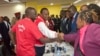 FILE - Jubilee Coalition presidential candidate Uhuru Kenyatta, 2nd left, accompanied by his running mate William Ruto, left, meets with Independent Electoral and Boundaries Commission (IEBC) members in Nairobi, Kenya, May 29, 2017.