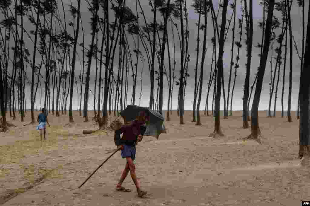 A Bangladeshi villager evacuates to a cyclone shelter on the coast in Cox's Bazar district.