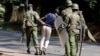 Riot policemen arrest a student of the University of Nairobi during a protests in Nairobi, Kenya, Sept. 28, 2017. 