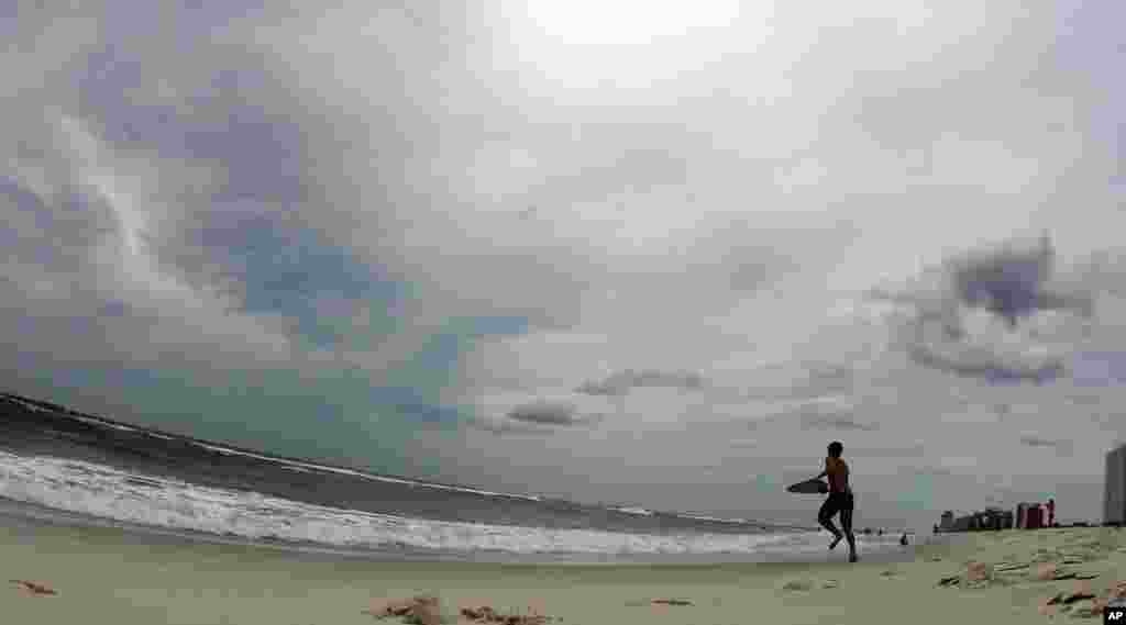 A boy plays in the surf in waves ahead of Tropical Storm Isaac in Orange Beach, Ala., Aug. 27, 2012.