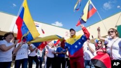 Dozens of demonstrators chant and wave Venezuelan flags in Doral, Florida, Feb. 18, 2014.