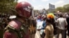 A riot policeman stands guard as opposition party supporters shout slogans during a march in Nairobi, Kenya, Oct. 9, 2017. 