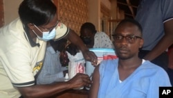 A man receives a shot of yellow fever vaccine at Kiswa Health Center III in Kampala, Uganda Tuesday, April. 2, 2024. (AP Photo)