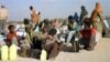 FILE - Somali refugees wait for a plane to take them home from Dabaab refugee camp in northern Kenya.