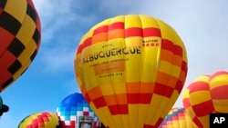 FILE - Hot air balloons are inflated during the annual Albuquerque International Balloon Fiesta in Albuquerque, N.M., Oct. 5, 2019.