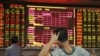 中国海南省海口市一名股民看着大屏幕上显示的股票信息。