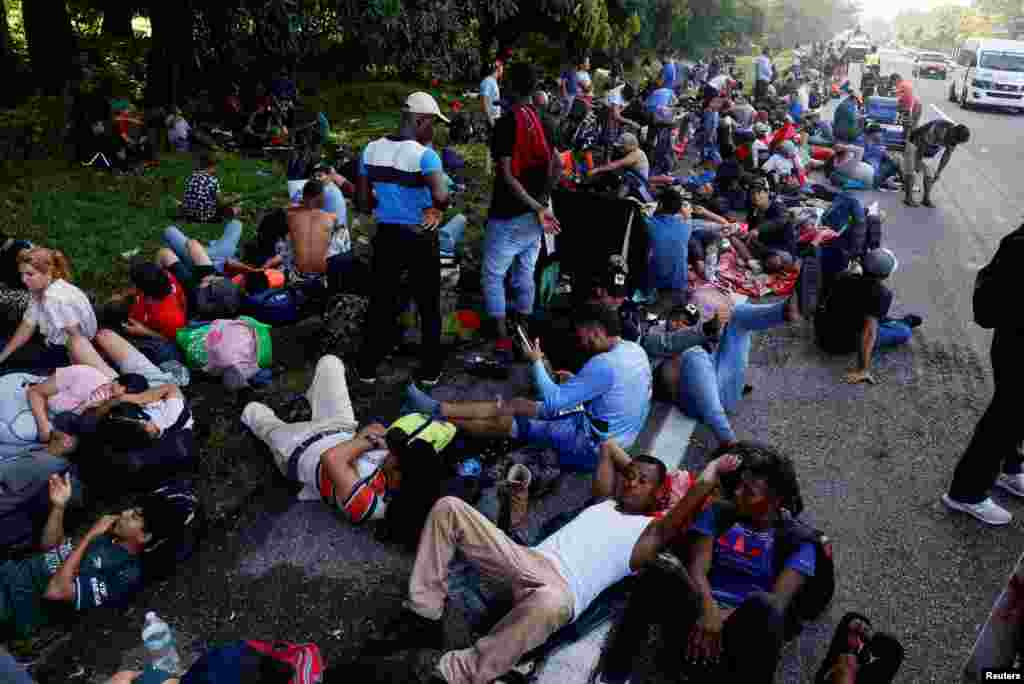 Migrants traveling in a caravan take a rest as they continue their journey to the U.S. border, in Cuntalapa, Mexico. A caravan of approximately 3,000 migrants set off on Nov. 5, 2024, from southern Mexico, headed toward the United States on the day when U.S. voters were deciding between U.S. presidential candidates Kamala Harris and Donald Trump.