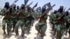 FILE - Al-Shabab fighters march with their weapons during military exercises on the outskirts of Mogadishu, Somalia, Feb. 17, 2011.