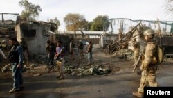 NATO and Afghan troops arrive at the site of a suicide attack in Jalalabad, Afghanistan, March 26, 2013. 