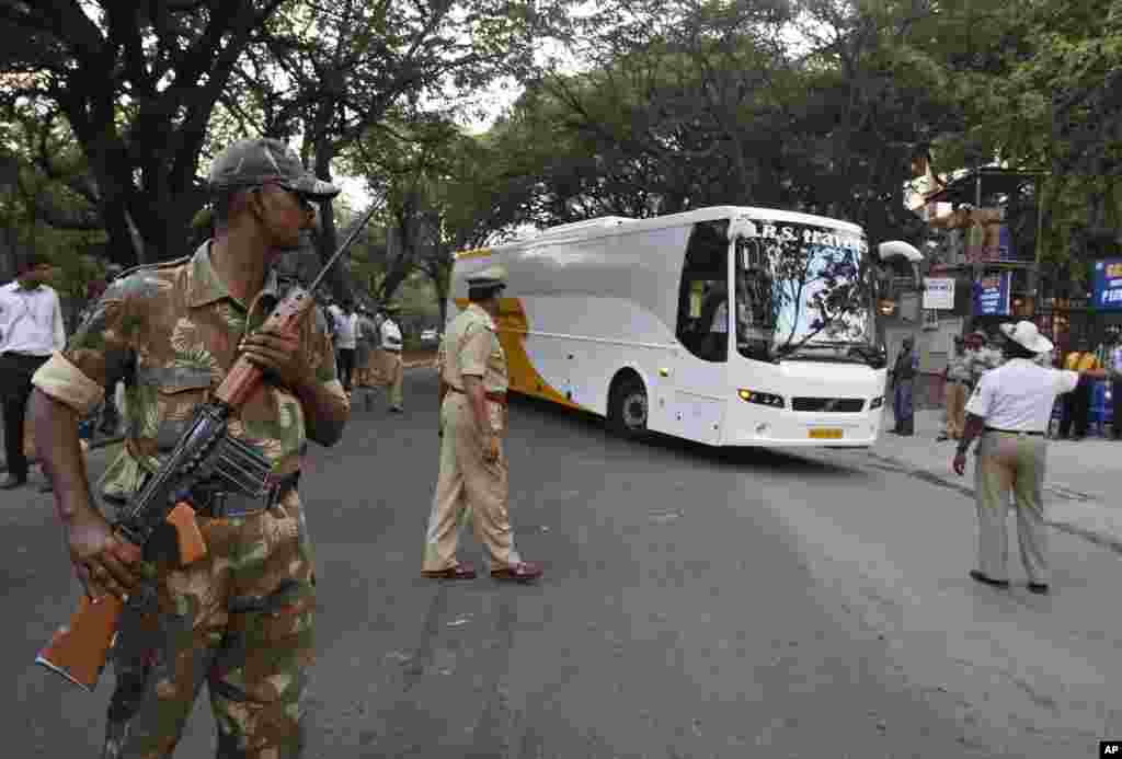 Indian security personnel stand guard as the bus transporting members of Indian cricket team arrives Chinnaswamy Stadium, the venue of first Twenty20 cricket match between India and Pakistan, in Bangalore, India, December 25, 2012.