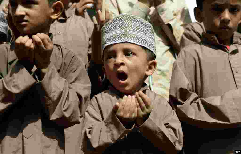 Seorang anak laki-laki Muslim ikut dalam shalat bersama untuk minta hujan di kota Mumbai, India.