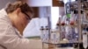 A researcher works near a blood test machine recently developed that is so sensitive it can spot a single cancer cell lurking among a billion healthy ones, Jan. 3, 2011.