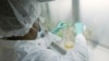 FILE - In this May 2020 photo provided by Eli Lilly, a researcher tests possible COVID-19 antibodies in a laboratory in Indianapolis. (David Morrison/Eli Lilly via AP, File)